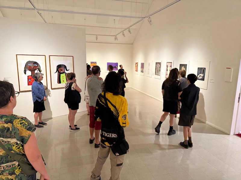 Visitors exploring an art exhibition at a community gallery
